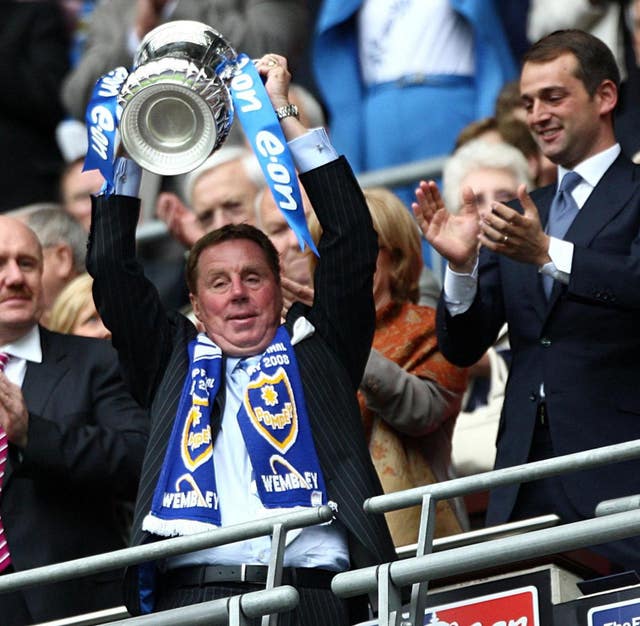 Portsmouth manager Harry Redknapp lifts the FA Cup after victory over Cardiff at Wembley