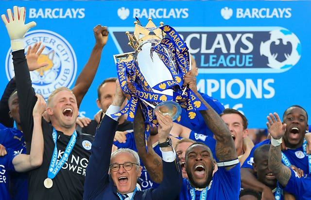 Leicester captain Wes Morgan and manager Claudio Ranieri lift the Premier League trophy. (Nick Potts/PA Images)