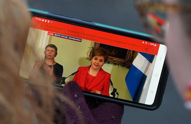 Members of the public outside Bute House in Edinburgh watching the press conference where First Minister Nicola Sturgeon announced she will stand down as First Minister for Scotland 