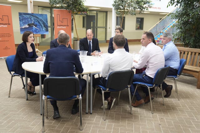 A group of people sit around a table