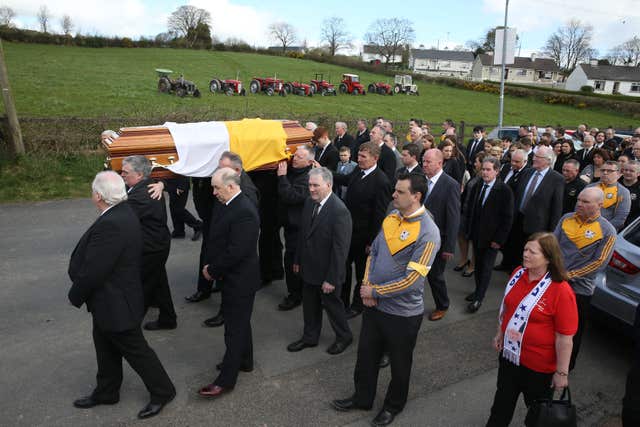 Tom McBride's funeral cortege passes a line of vintage tractors, some of which belonged to the singer (Brian Lawless/PA)