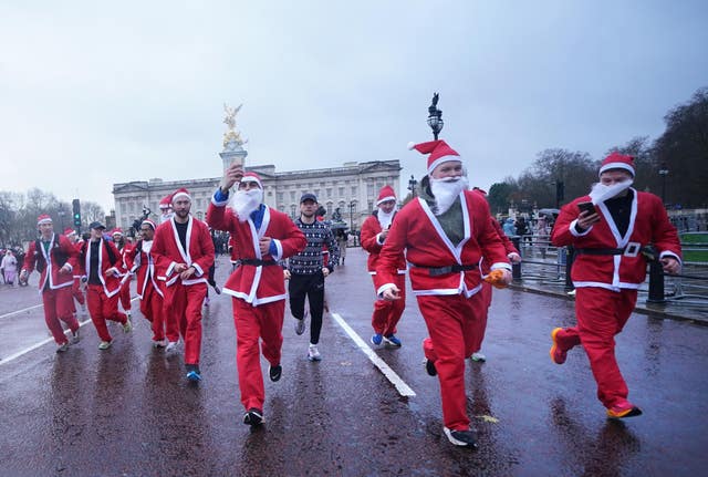 People in costumes taking part in the Scrambled Legs Running Club 10k Santa Run in London