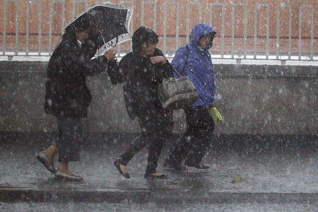 Three women running through a storm 