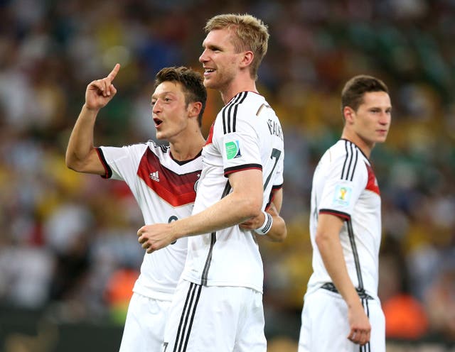 Mesut Ozil, pictured left, won the World Cup with Germany four years ago