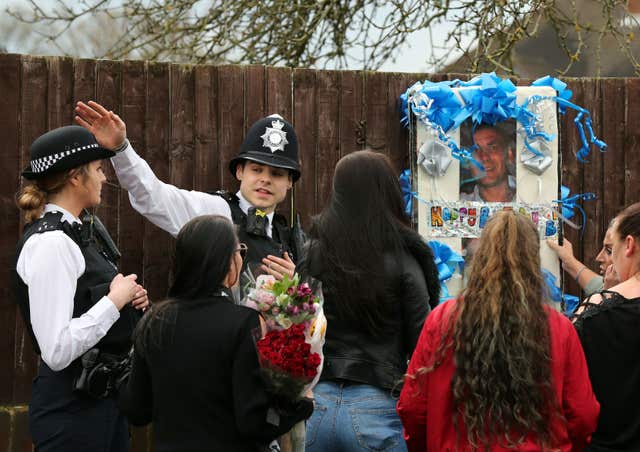 Police stopped the friends and family from stapling their tributes onto fences (Gareth Fuller/PA)