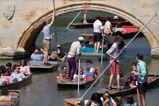 People enjoy punt tours along the River Cam in Cambridge