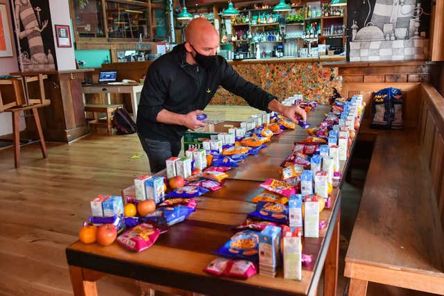 James Koch prepares free packed lunch bags for delivery at the Gallimaufry pub in Bristol