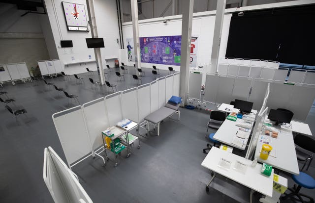 A vaccination booth next to a waiting area inside Ashton Gate Stadium in Bristol which is acting as a mass vaccination centre (Andrew Matthews/PA)