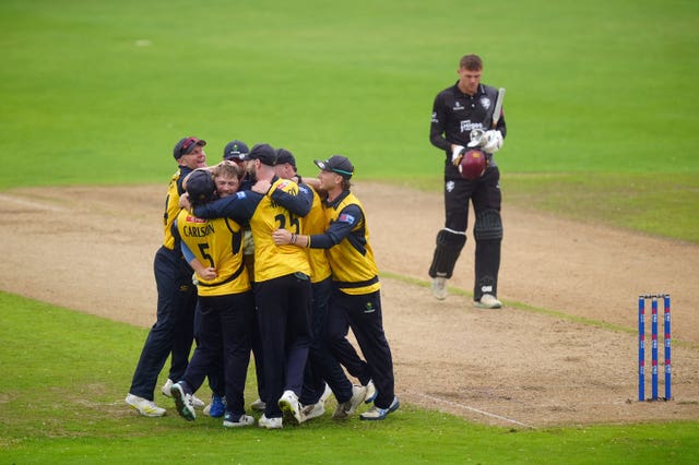 Glamorgan celebrate in a huddle after beating Somerset at Trent Bridge