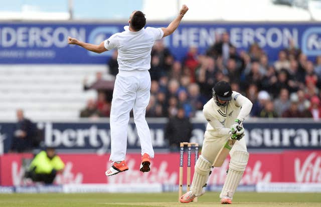 England's James Anderson leaps with joy after dismissing New Zealand's Martin Guptill on a rain-affected day at Headingley