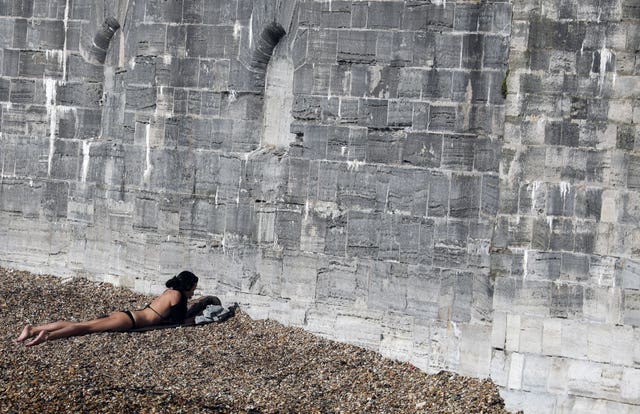 A woman sunbathes in Old Portsmouth, Hampshire