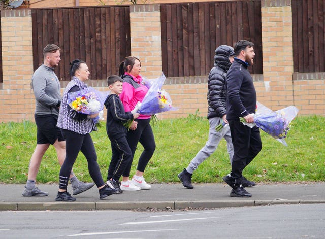 People are leaving floral tributes at the scene (Ben Birchall/PA)