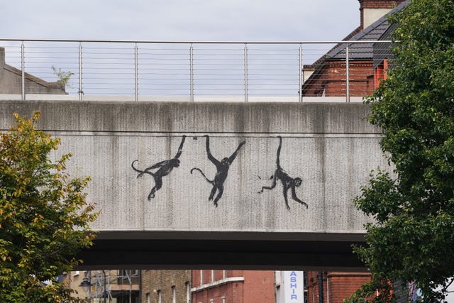 Banksy's monkey artwork on a bridge