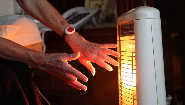 An elderly lady with her electric fire on