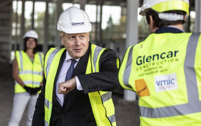 Prime Minister Boris Johnson bumps elbows with scientists during his visit to the construction site of the new vaccines Manufacturing and Innovation Centre (VMIC) in September 2020