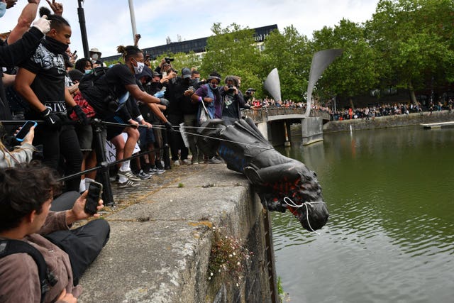 The statue of Edward Colston being thrown into Bristol Harbour during Black Lives Matter protests in June 2020. 