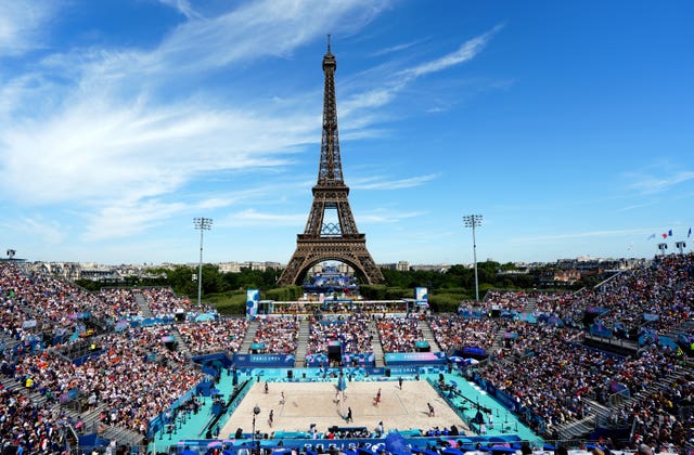 Beach volleyball taking place in front of the Eiffel Tower