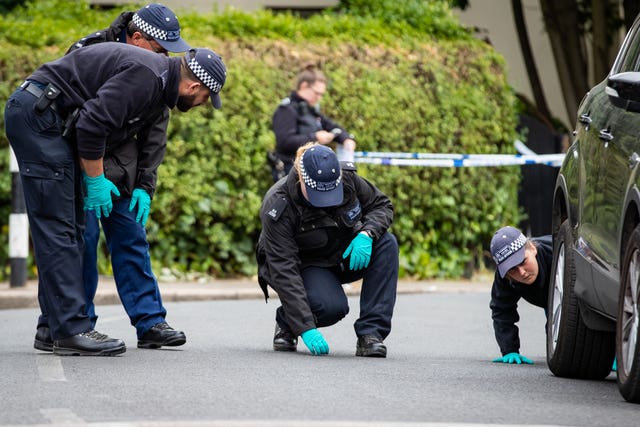 Police forensic officers looking for evidence at the scene in Energen Close, Harlesden