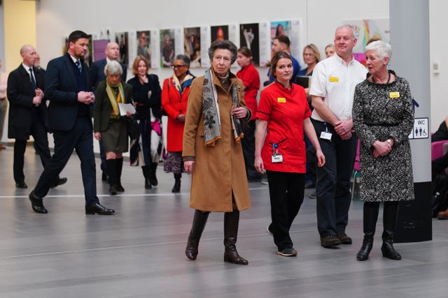 Anne walks through the atrium of Southmead Hospital's Brunel Building 