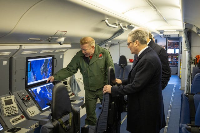 Prime Minister Sir Keir Starmer is shown around a plane during a visit to RAF Lossiemouth in Moray
