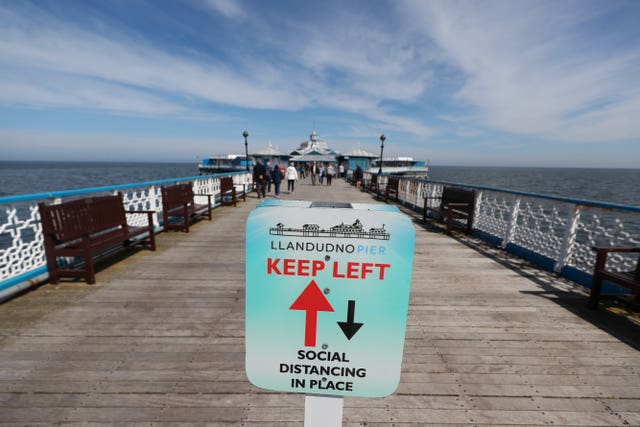 A social distancing sign on the pier in Llandudno, Wales (Peter Byrne/PA)
