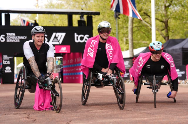 David Weir (left to right), Marcel Hug and Daniel Romanchuk after the men’s wheelchair race during the TCS London Marathon