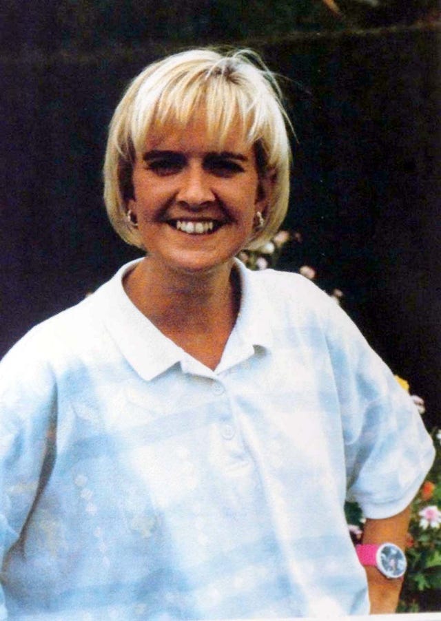 Head and shoulders shot of a blonde woman in a pale shirt