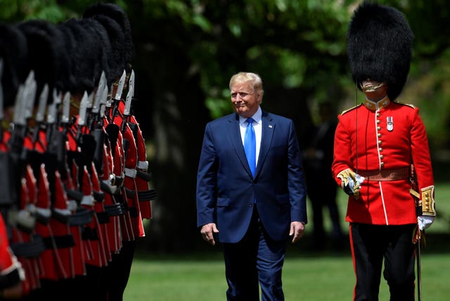 US President Donald Trump inspects the guard of honour during a ceremonial welcome at Buckingham Palace