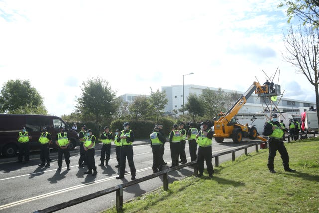 Police formed a cordon as emergency services used a cherry picker to remove protesters at Broxbourne, Hertfordshire