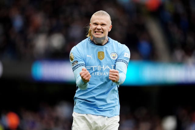 Erling Haaland clenches his fists in celebration after scoring a goal for Manchester City