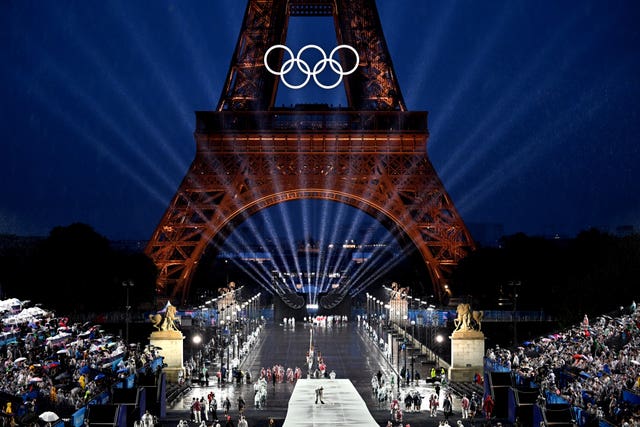 The Eiffel Tower is lit up with the Olympic rings