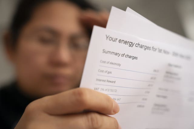 A person looks at an energy bill