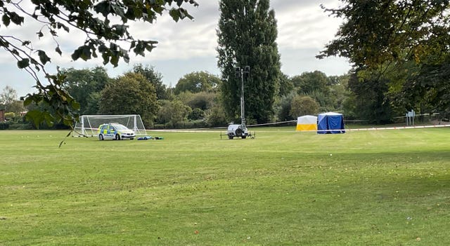 A police car and forensic tents at the scene on a playing field in Craneford Way, Twickenham, south-west London, where an 18-year-old was stabbed on Tuesday afternoon