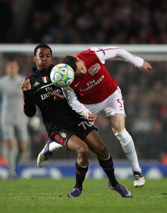 AC Milan’s Robinho, left, and Arsenal’s Laurent Koscielny battle for the ball in the air