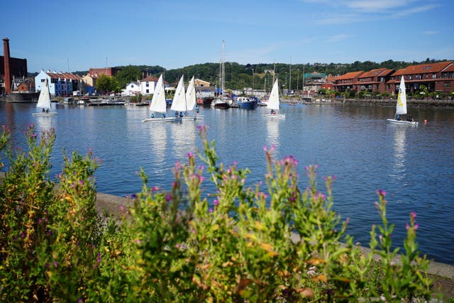 People enjoy the warm weather at Bristol Harbour as the heatwave continues in the UK