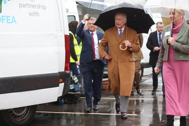 The King, holding an umbrella, at the launch of the Coronation Food Project in 2023