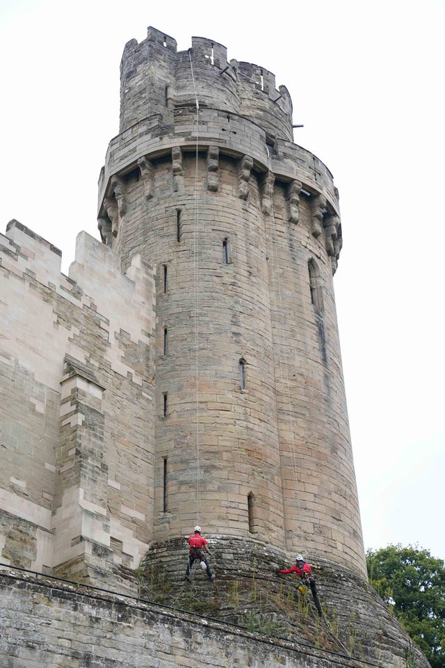 Building restoration specialists abseil down the walls of Warwick Castle’s south front