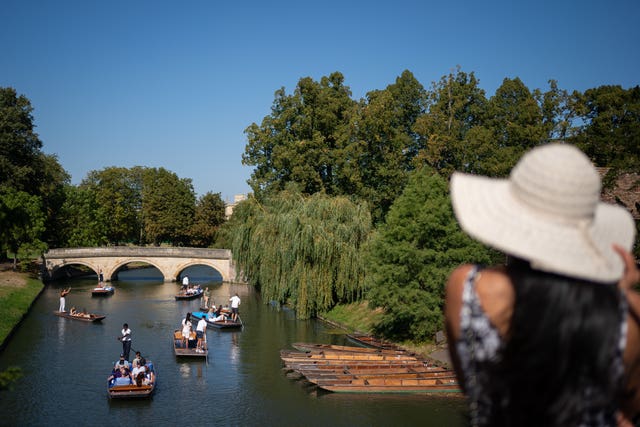 People make the most of the hot weather as they enjoy punt tours along the River Cam in Cambridge 