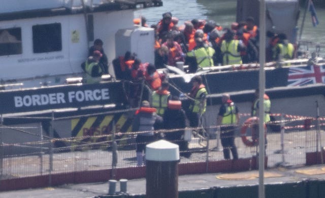 A group of people thought to be migrants are brought into Dover, Kent