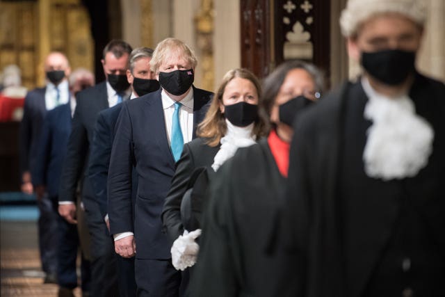 Prime Minister Boris Johnson (centre) processes through the Central Lobby with other party leaders on their way from the House of Lords after listening to the Queen’s Speech during the State Opening of Parliament in the House of Lords (Stefan Rousseau/PA)