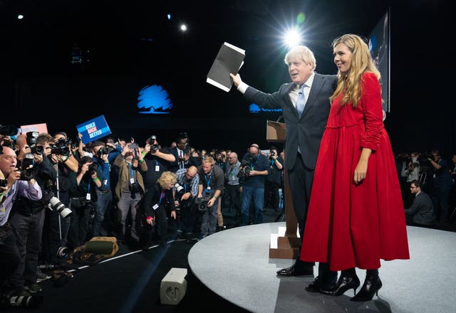 Prime Minister Boris Johnson is joined by his wife Carrie on stage after delivering his keynote speech at the Conservative Party conference in Manchester 