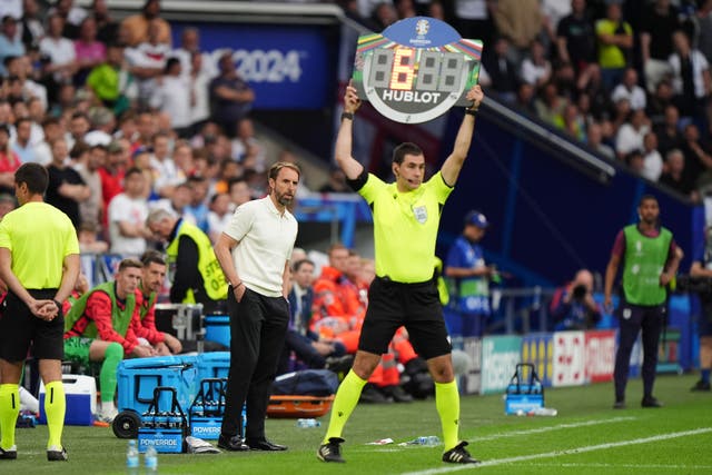 Gareth Southgate alongside the fourth official holding up a board showing six minutes of added time