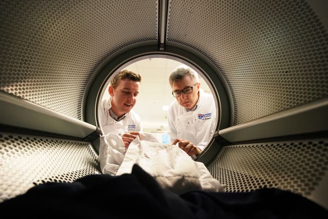 Scientists check clothes in washing machine