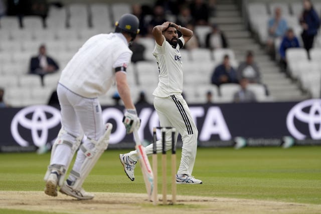 Mohammed Siraj reacts by putting his hands behind his head after a near miss