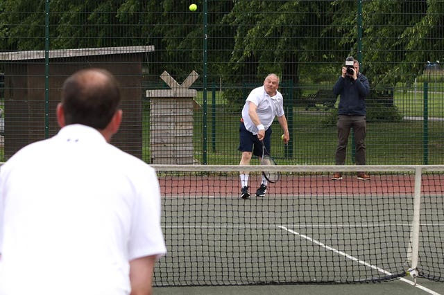 Sir Ed Davey playing tennis at Victoria Park Tennis, Newbury, Berkshire while on the General Election campaign trail