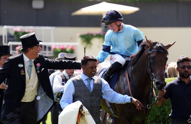 Tom Marquand aboard Merchant shakes hands with Harry Herbert, after winning at Royal Ascot