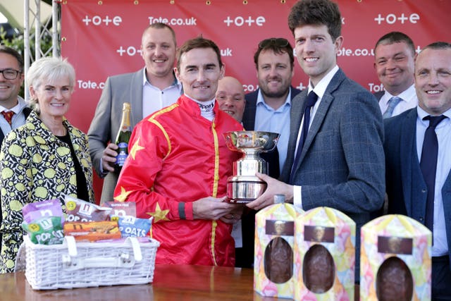 Tudhope and trainer Adam Nicol hold the Queen's Cup after their Musselburgh success 