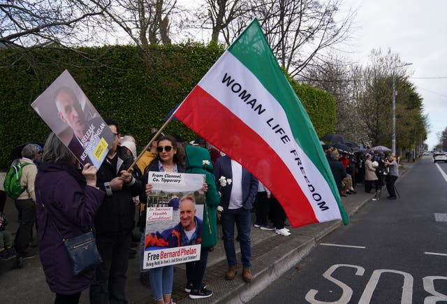 People attend a vigil for Bernard Phelan outside the Iranian Embassy in Dublin