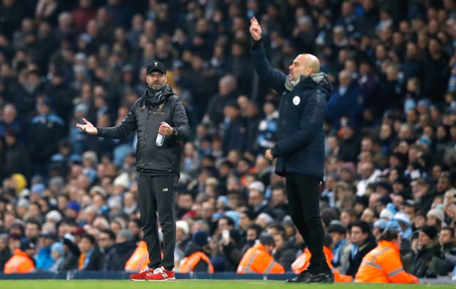 Liverpool boss Jurgen Klopp (left) and Manchester City manager Pep Guardiola are battling for glory 