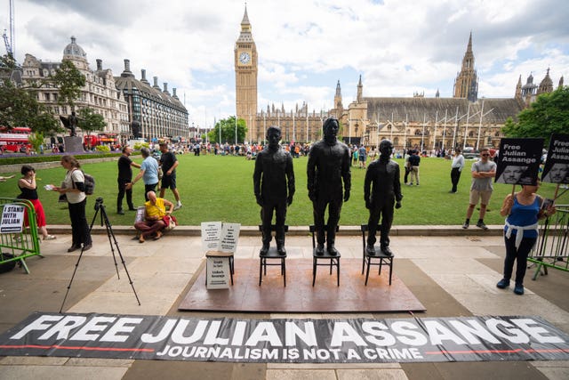 A sculpture called Anything To Say, which features life-sized bronze figures of whistleblowers (left-right) Edward Snowden, Julian Assange and Chelsea Manning, each standing on their own individual chair, is unveiled at Parliament Square, London.